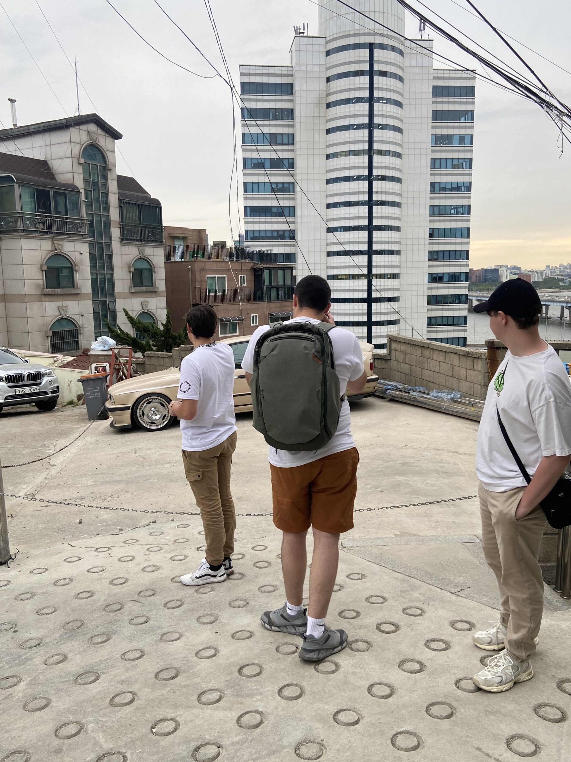 Besties out in a Seoul alley, city skyline behind
